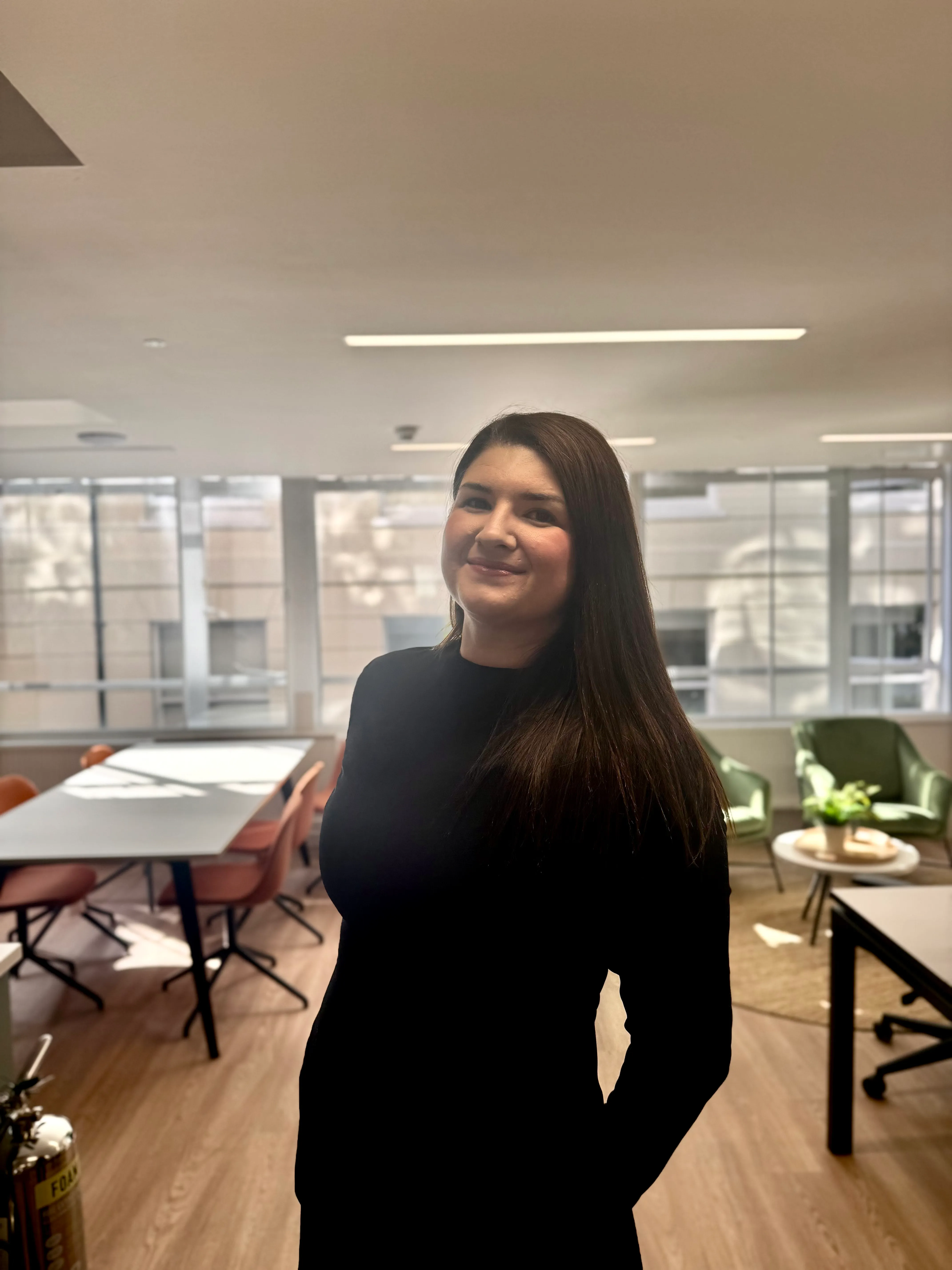 Maddey standing in a bright office space